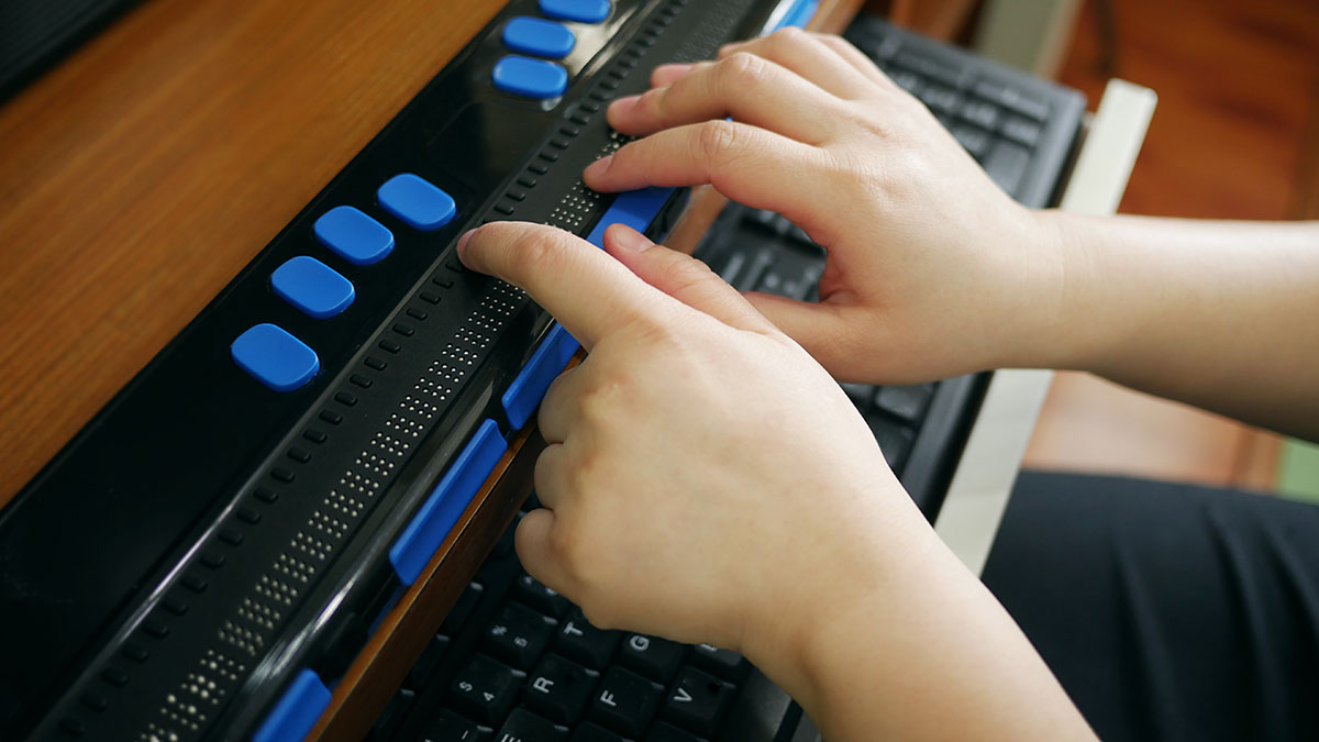 Person Using Braille Keyboard